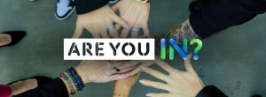 Diverse hands joined in unity with bold text “ARE YOU IN?” at the center.